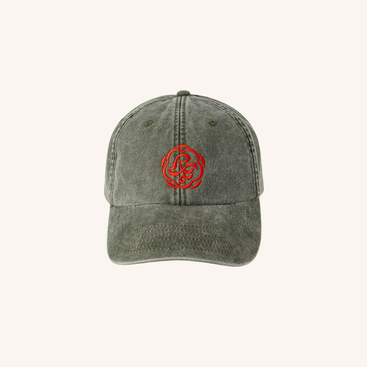 A washed dark gray baseball cap with a red embroidered circular logo on the front, set against a solid off-white background.